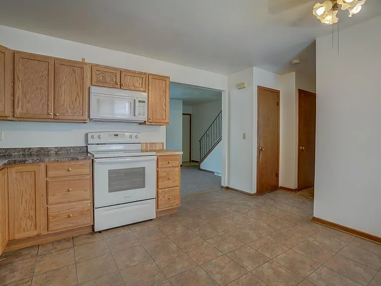 Kitchen pantry, basement access, and 1/2 bath on main around the corner to the right