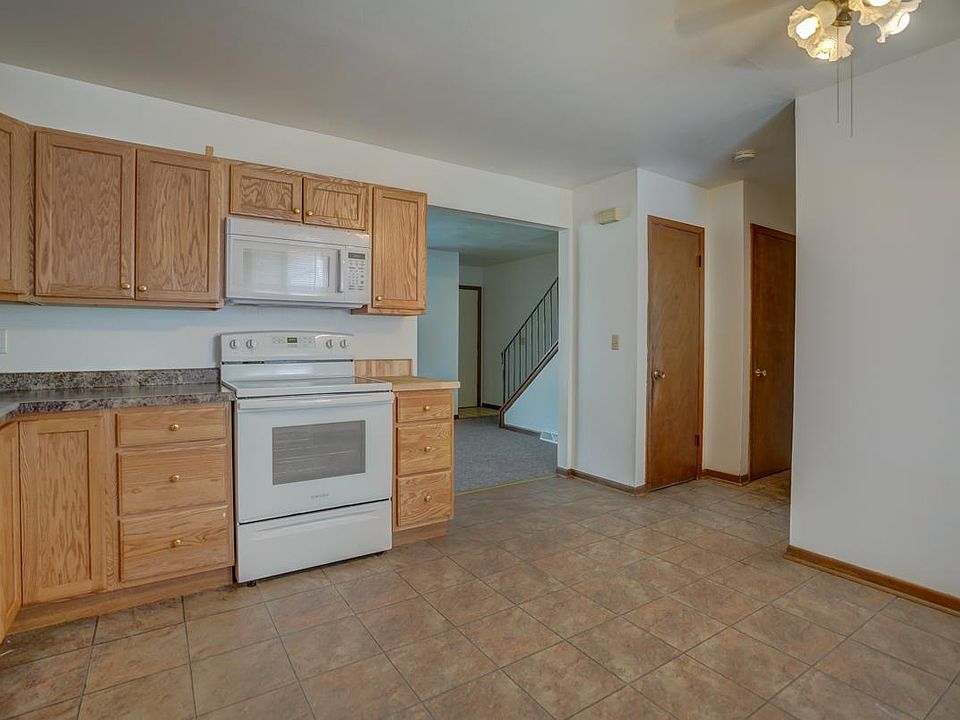 Kitchen pantry, basement access, and 1/2 bath on main around the corner to the right