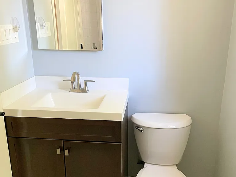 Bathroom with vanity, medicine cabinet and extra towel storage