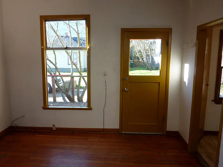 Living Room, front door leading out to deck. West-facing.