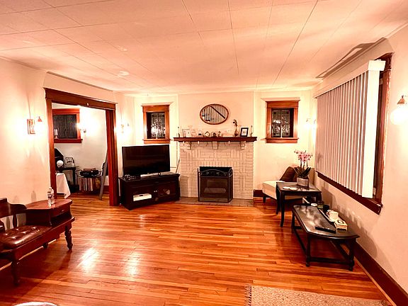 Living room with decorative fireplace and stained-glass windows