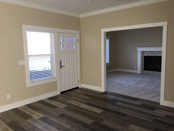 Family room with carpeted living room with gas fireplace.
