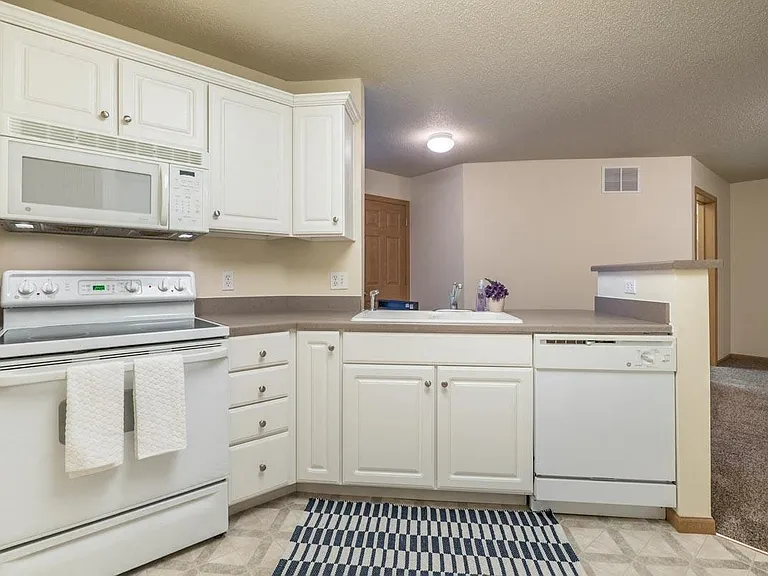 A warm and inviting kitchen layout makes meal prep and hosting guests a breeze.