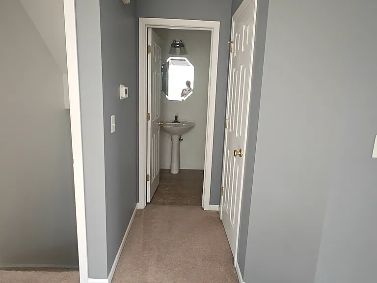 Half bath view (with coat closet on the right) from the living area