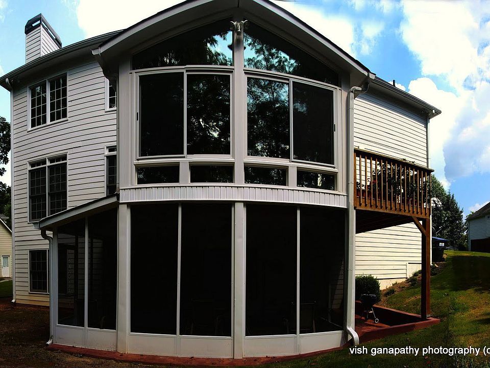 Rear view of home.  All season sun-room and screened-in porch