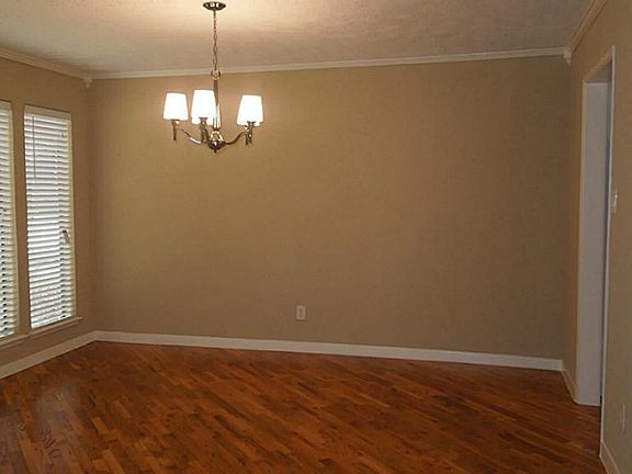 Dining room features gorgeous hardwood flooring and lots of windows