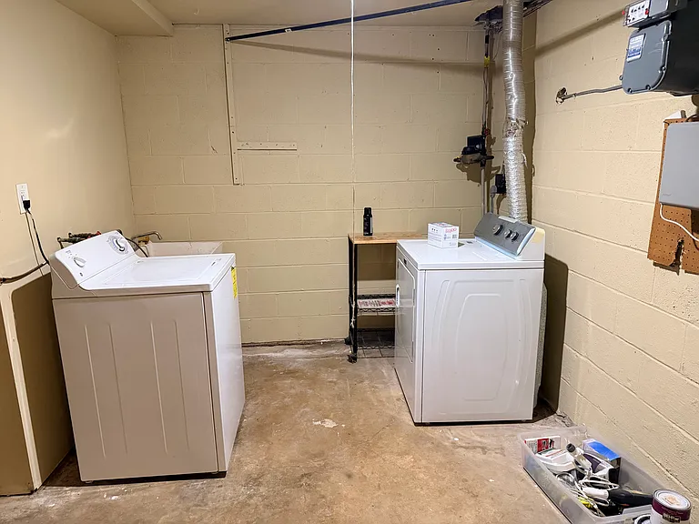 Utility room in basement with washer and dryer