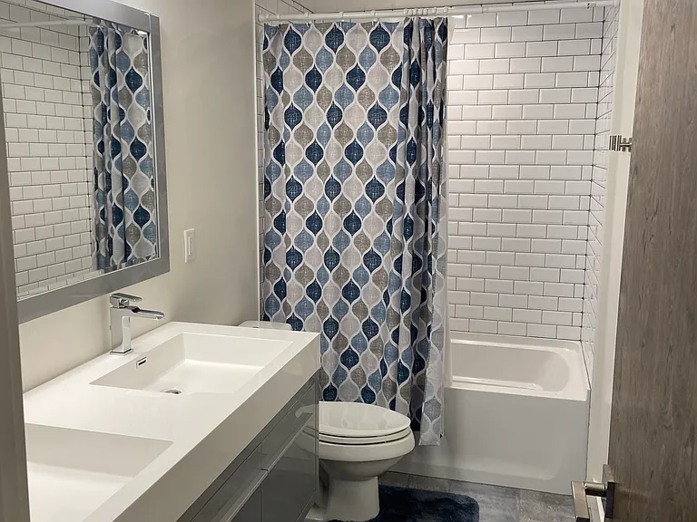 3rd bedroom adjoining bathroom with tub/shower and 2 sinks