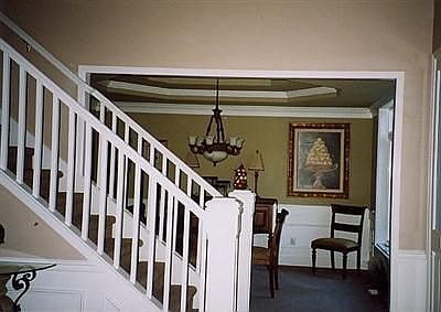 Entry, stairs and formal Diningroom with double coffered ceiling.