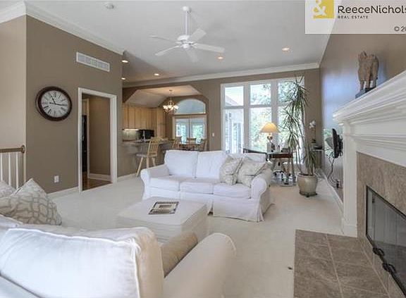 View of living space into the kitchen and looking thru to the fabulous Sun Room.  Wide open spaces make this a wonderful floorplan.