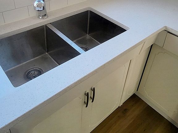 Brand new granite countertops and large sink looking out to side backyard.