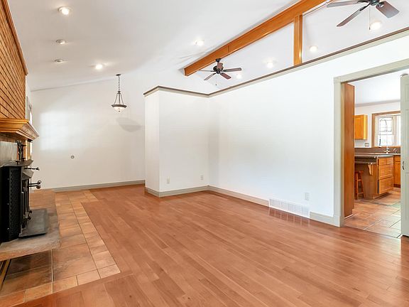 Vaulted ceilings connect the living room and kitchen spaces