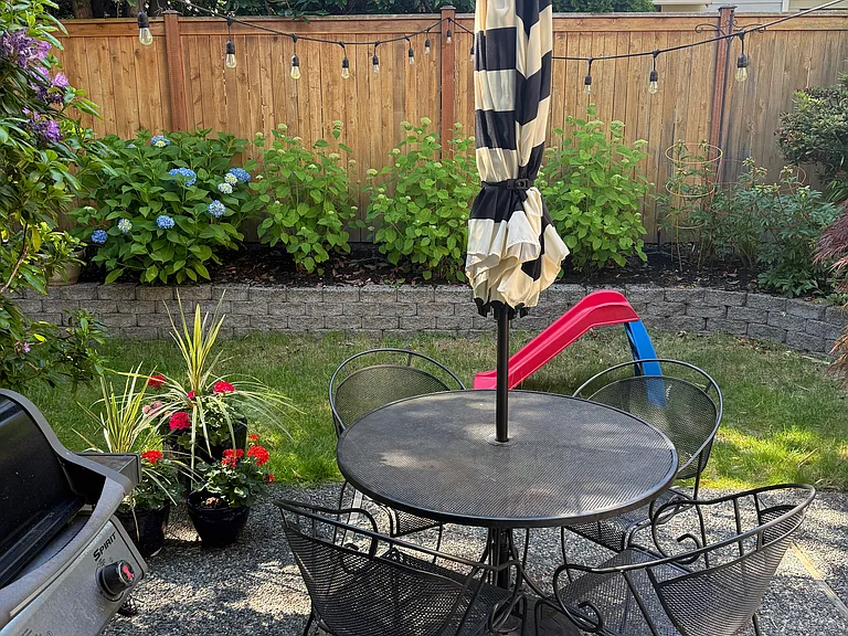Fully fenced Backyard off of the kitchen and dining room with plenty of room for entertaining and play!