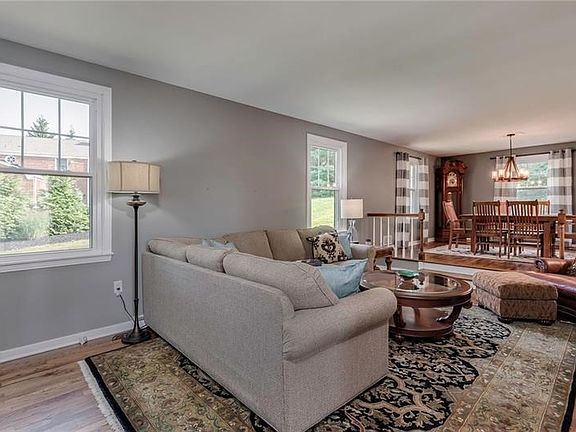 The sunken living room off of the formal dining area is perfect for guests to gather during any occasion.