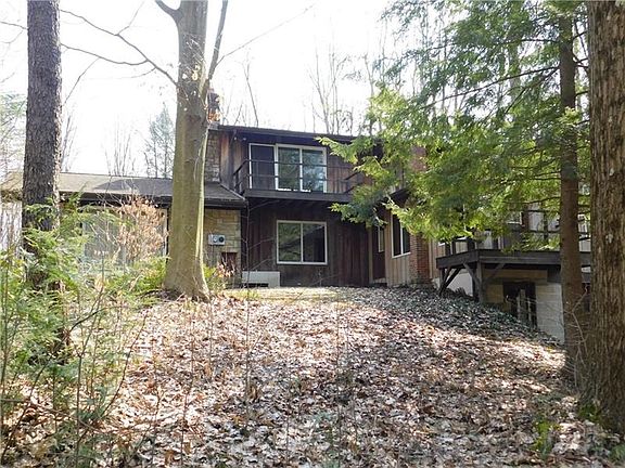 SIDE VIEW OF HOME AS YOU TRAVEL UP THE DRIVEWAY/DECK OVERLOOKS THE WATERFALL