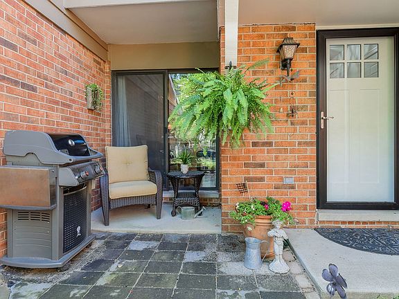 A beautifully landscaped walkway, updated paver patio, and a new front and storm door greet your gue