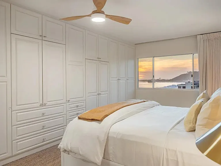 Enjoy the sunset from the comfort of the bedroom, where coastal views meet relaxation.