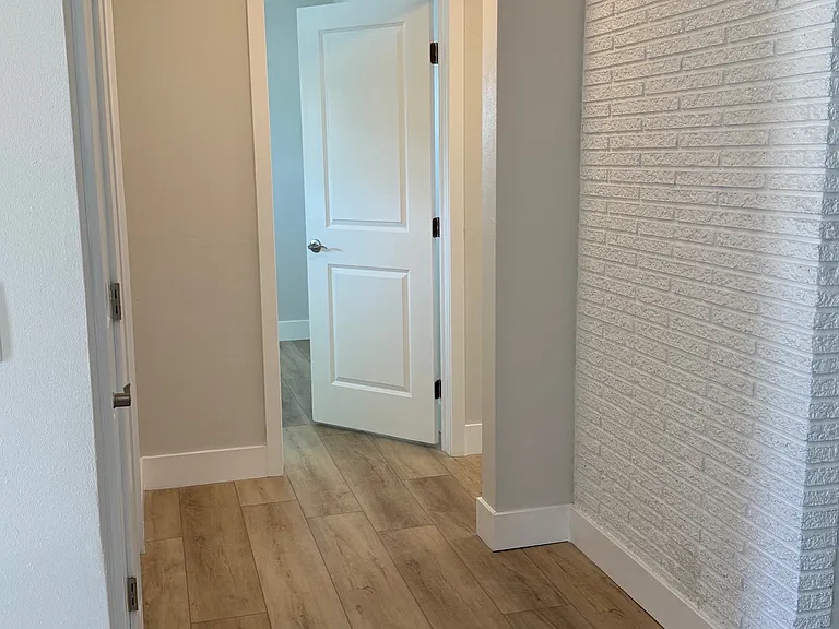 Hallway to two bedrooms and hall full bath