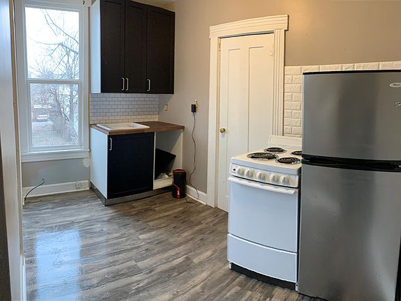 Kitchen near complete! New cabinets, new floor, new faucet and new paint!