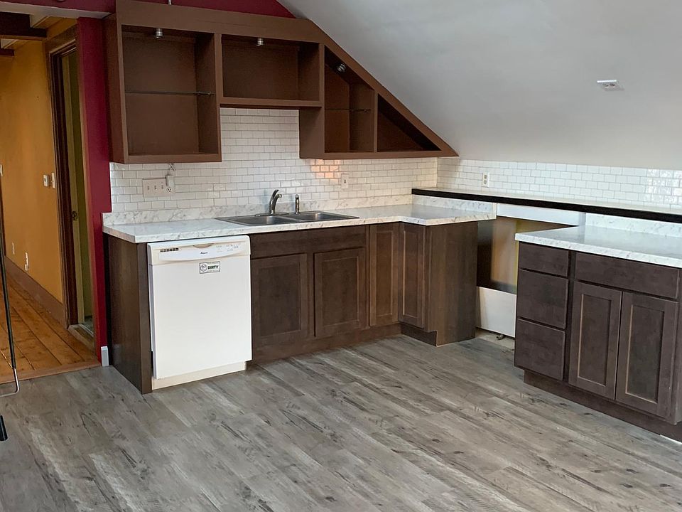 Newly remodeled kitchen with new floor, cabinets, countertops and backsplash. Gas oven is ordered!