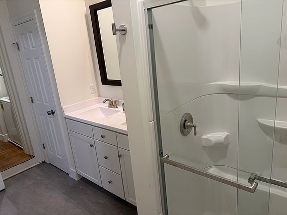 Walk-in shower and double sink in a very large bathroom