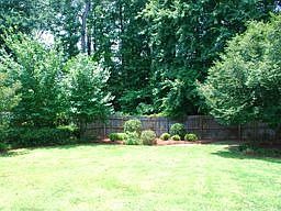 Private fenced in backyard with covered patio off of living room