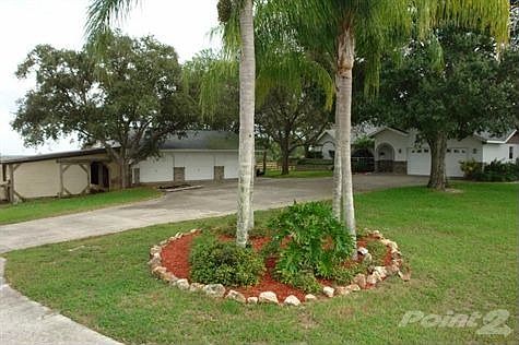 Home w/ 5 car garage + 2 stall barn