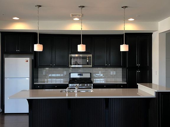 Quartz countertops & tile backsplash- fridge recently updated to stainless steel model