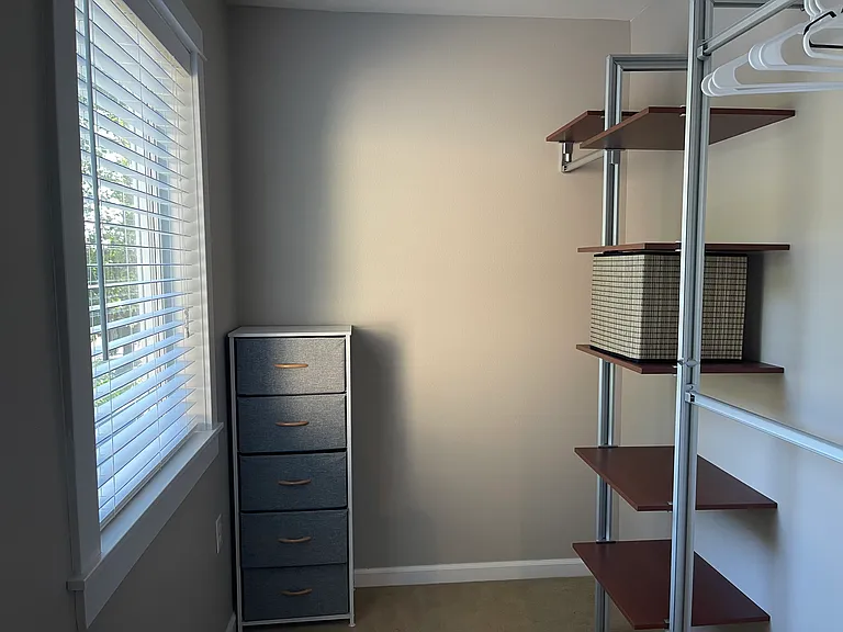 Large walk-in closet with a window