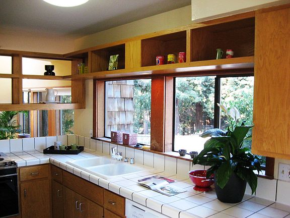 Kitchen looks in to the living room and across to the park.