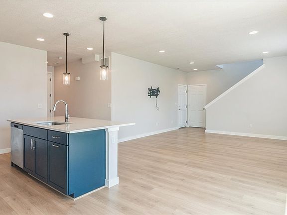 Open concept main floor with powder room (1/2 bath) by front door.