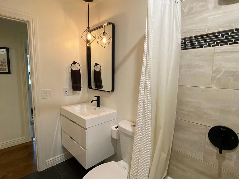 updated bathroom with 36" floating vanity and all new, matte black fixtures