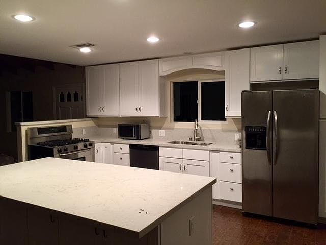 Beautiful new kitchen with large island for storage and seating.