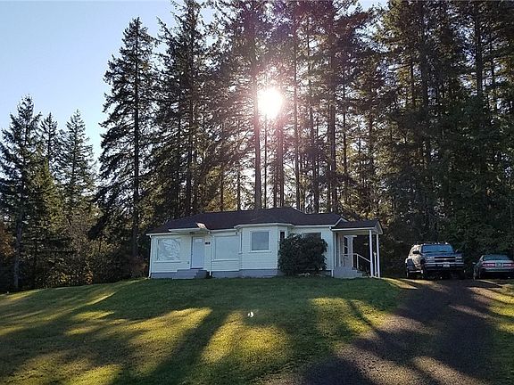 Morning sun behind house in wooded area of this .7 acre (over 30,000 s ft) lot with circle driveway in quiet neighborhood. speed limit on road is 25 mph.  Union Marina is just 1/2 mile down the hill.