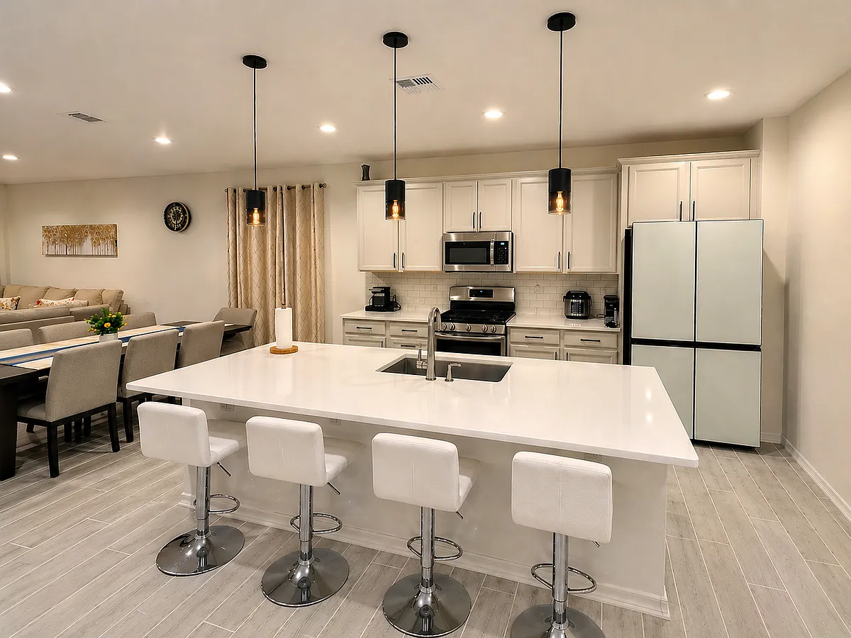 Stunning kitchen with large island, quartz countertops, modern pendant lighting, and Samsung Bespoke Refrigerator - 17712 W Bajada Rd