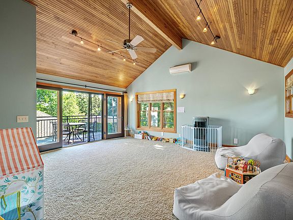 Upstairs media room, 14' ceilings, french doors to outside deck off MBRM.
