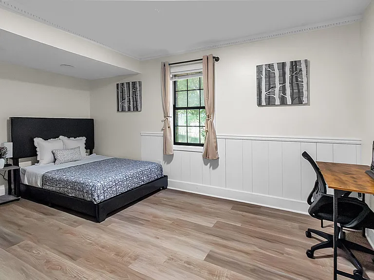 Spacious, furnished bedroom with a full bed & window with back-out curtains.