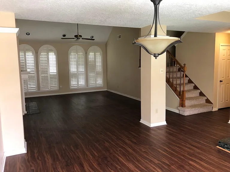Camera man is Standing in dining room looking at the living room.