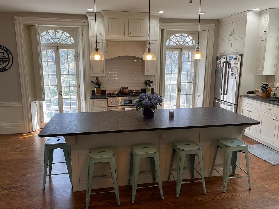 Light filled kitchen with high end appliances, cabinets and counters.