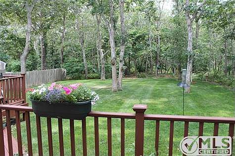 Back yard from deck. There is a path to the beach from the