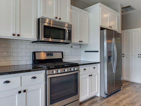 Beautiful, open galley kitchen with subway backsplash