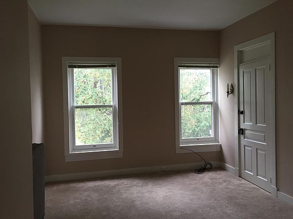 Living Room in front of home. Wood blinds included.