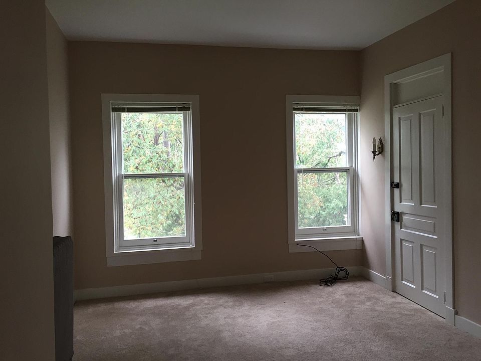 Living Room in front of home. Wood blinds included.