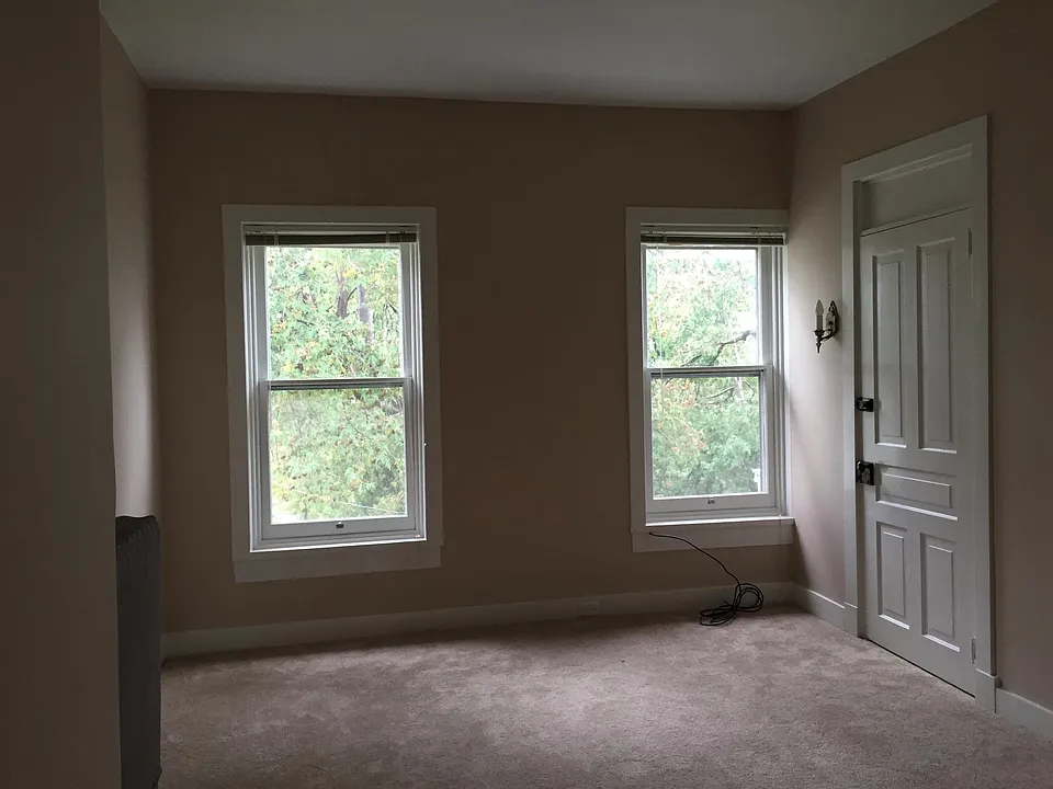 Living Room in front of home. Wood blinds included.