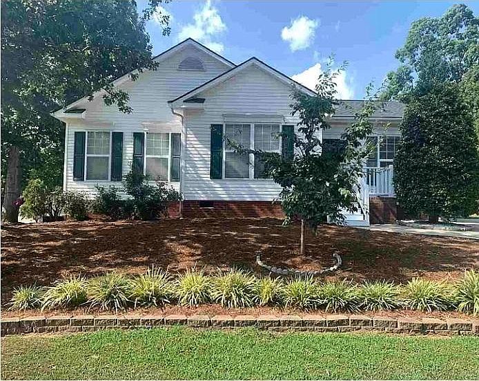 front porch with driveway to the right