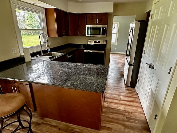 Brand new kitchen with granite countertops, stainless steel appliances, and top quality custom cabinets