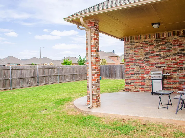 Backyard patio and fenced property.