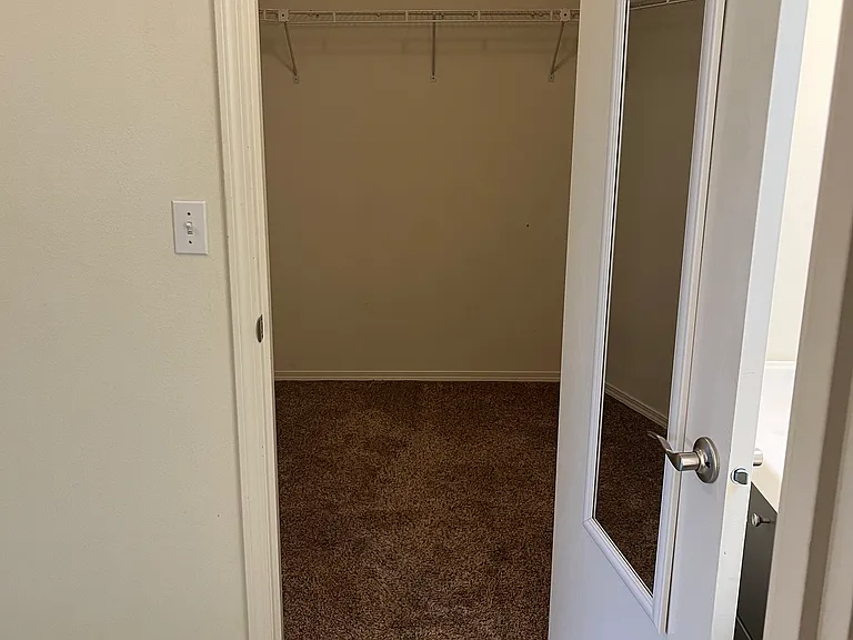 Primary bedroom walk-in closet