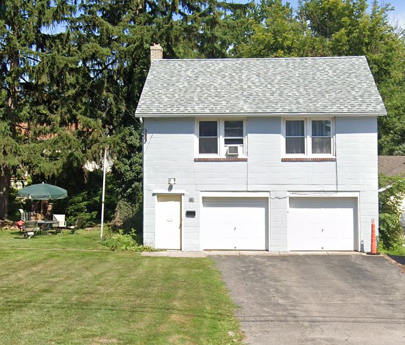 View from street with large parking area and nice yard.