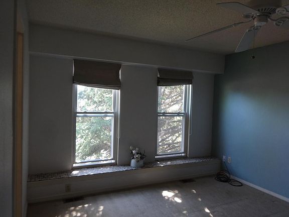 Master bedroom with 2 large windows and window seat facing e